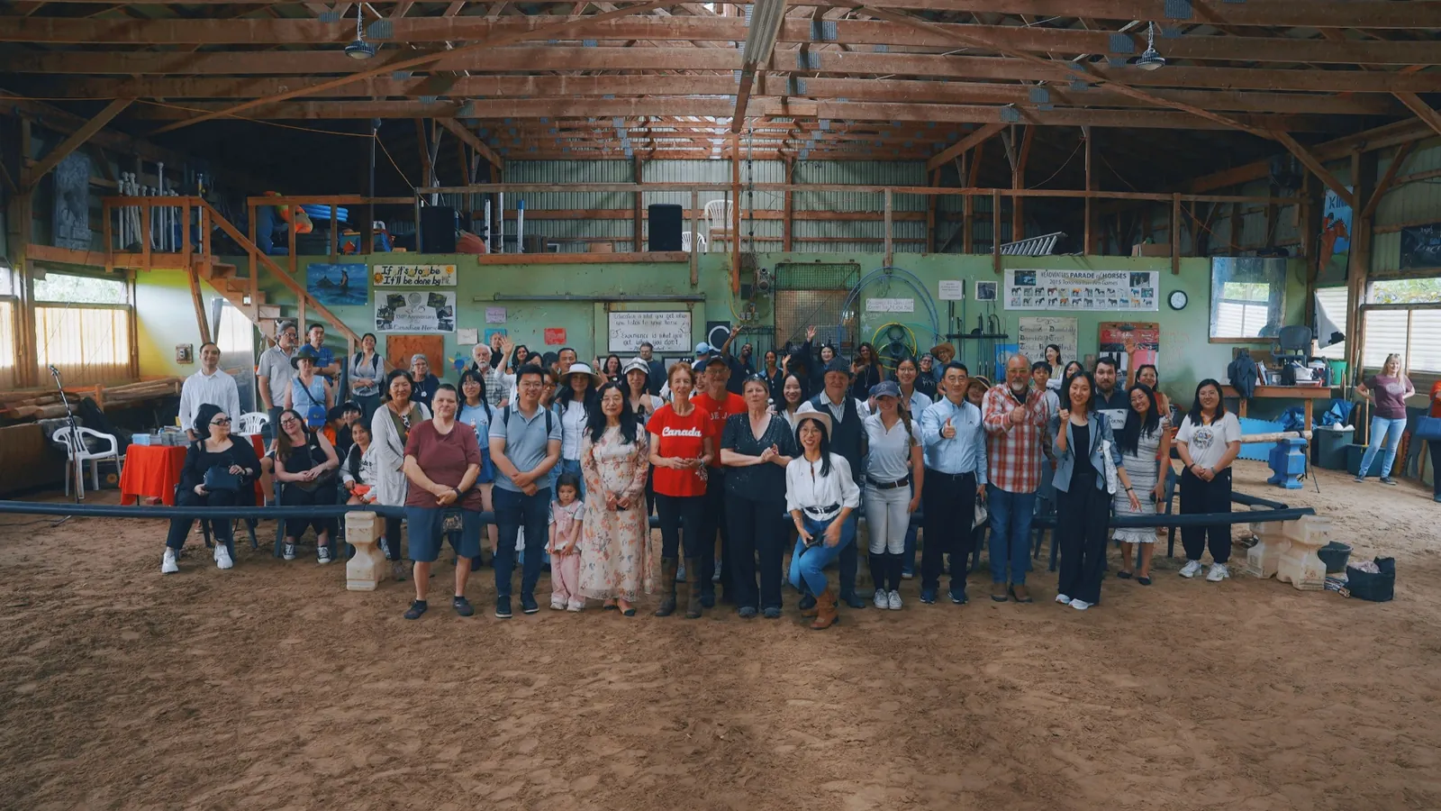 Participants and guests gathered for a group photograph in the arena