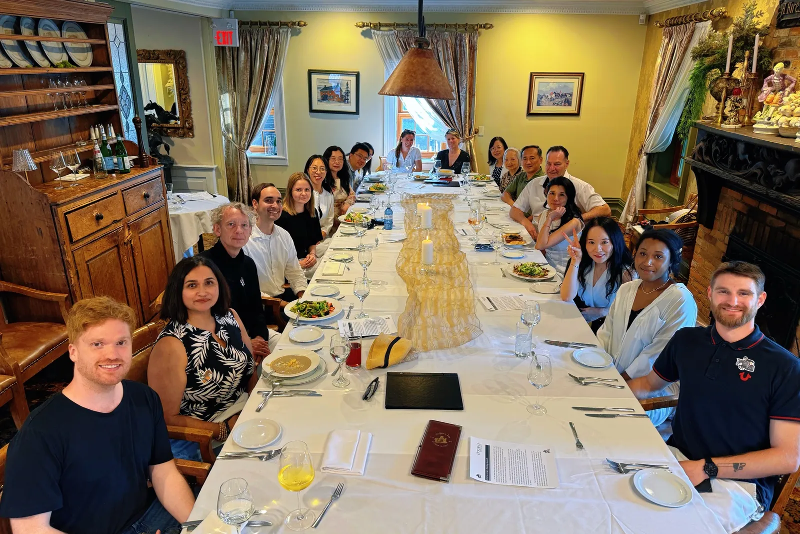 Guests gathered around a long table for dinner at the historic carriage inn