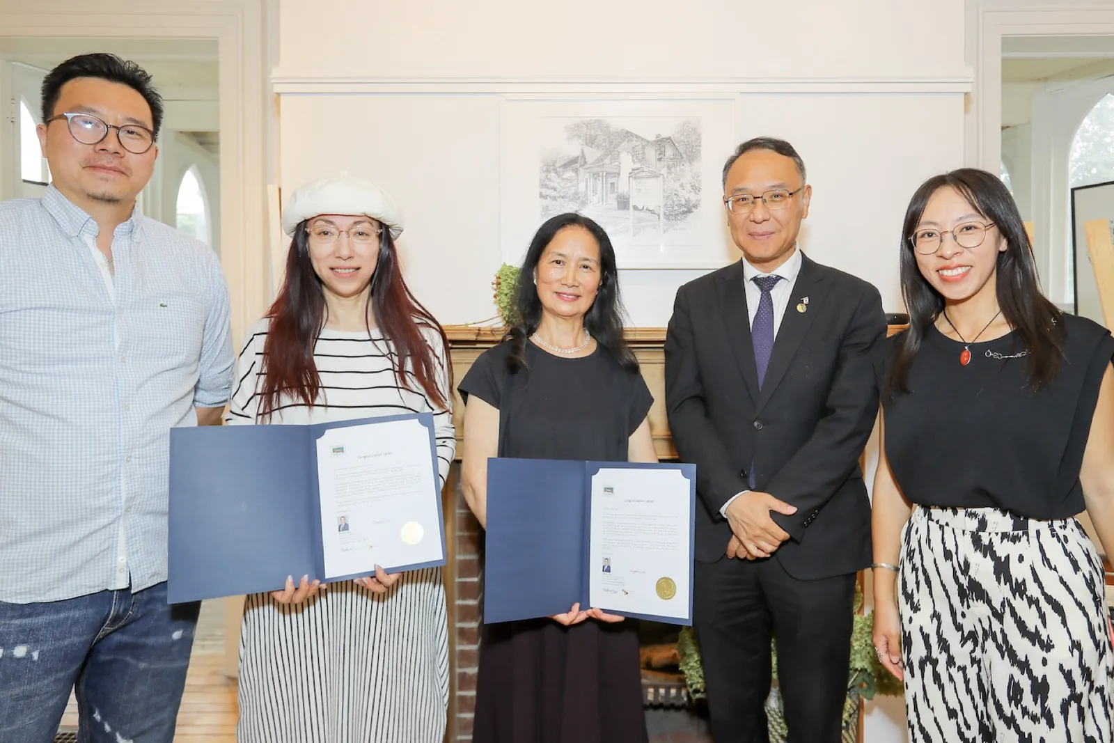 Artist and guests holding congratulatory certificates