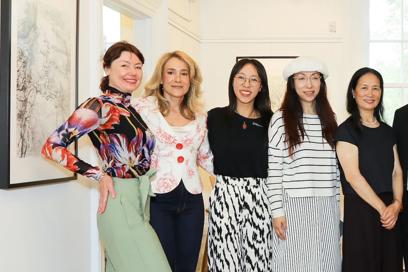 Guests gathered beside artworks at the exhibition