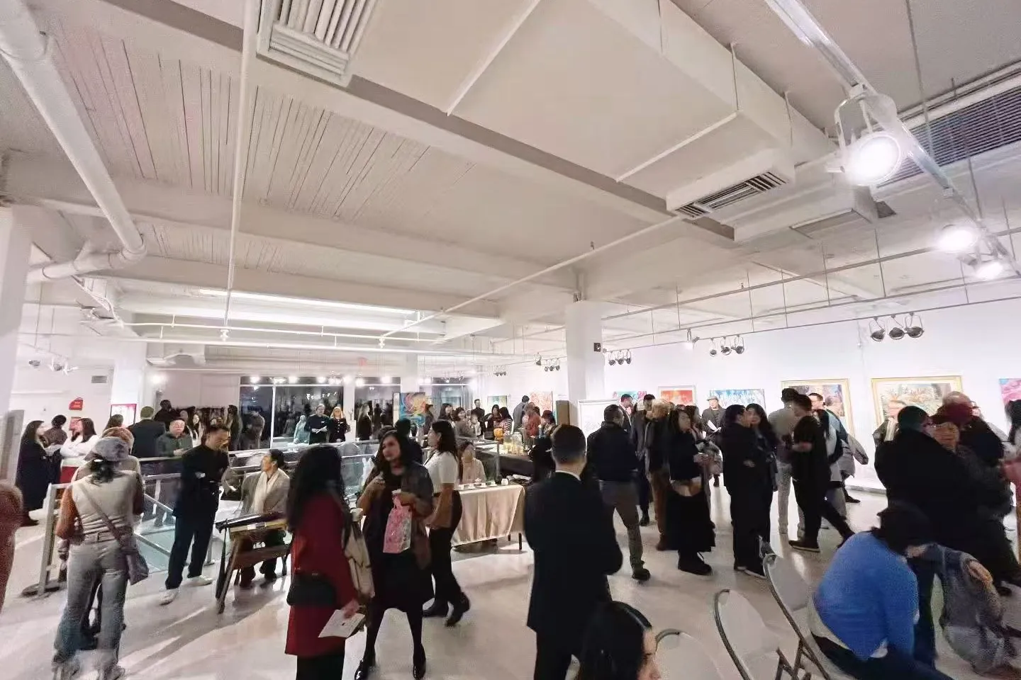 Visitors meeting among artworks during the opening reception