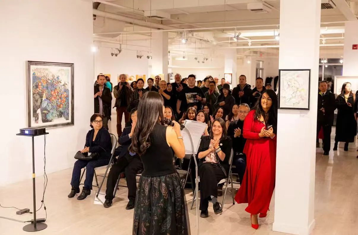 A speaker addressing guests during the exhibition program