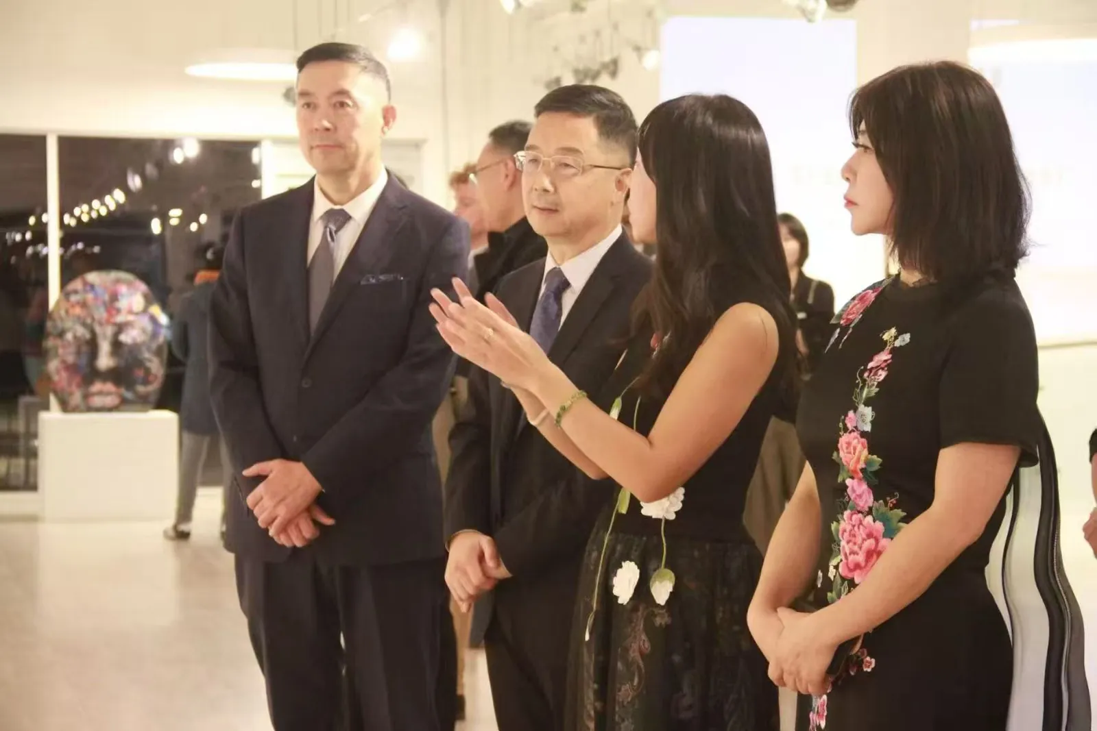 The curator speaking with guests during the opening program