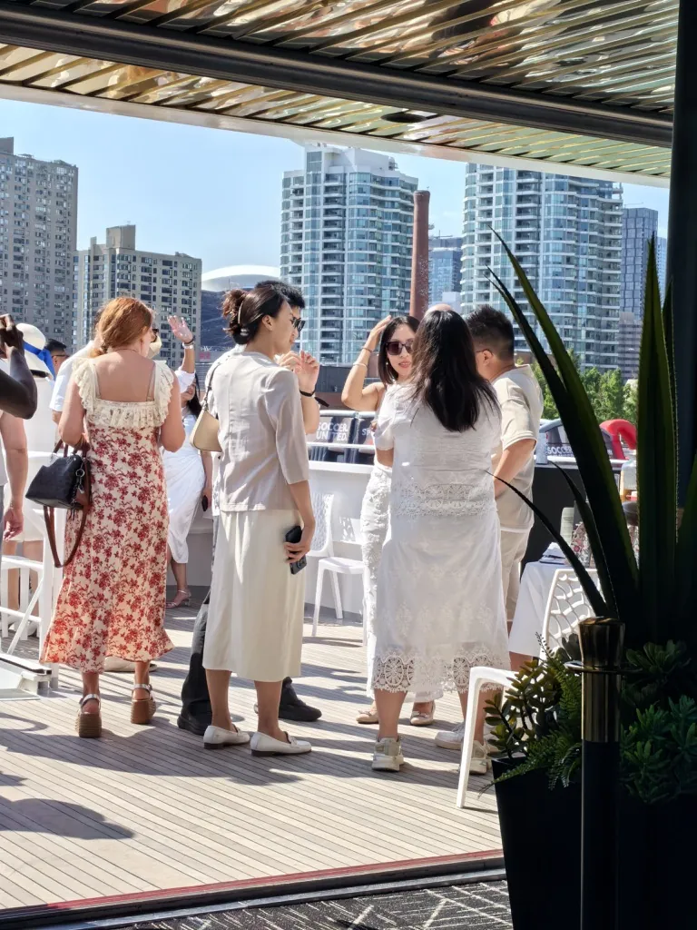 Guests speaking on the upper deck during the white cruise party
