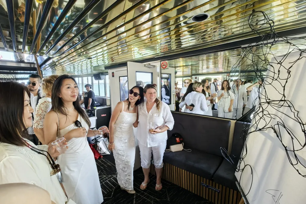 Guests viewing a wire artwork inside the cruise boat