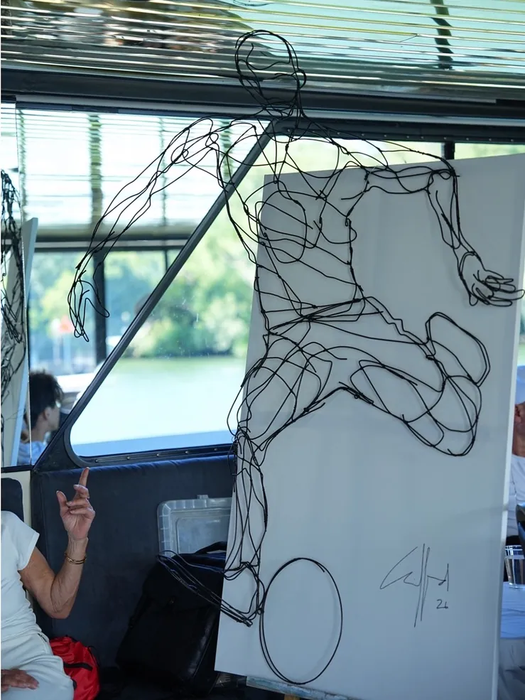 A wire sculpture of a football player displayed on the cruise boat